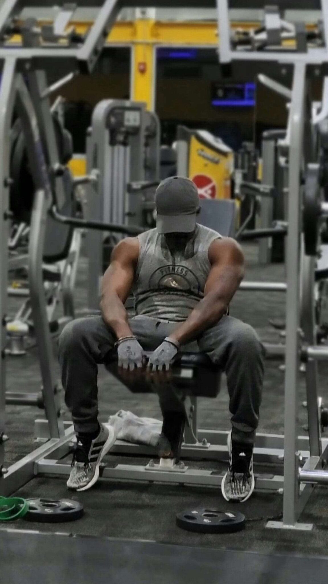 A man sitting on a bench in a gym