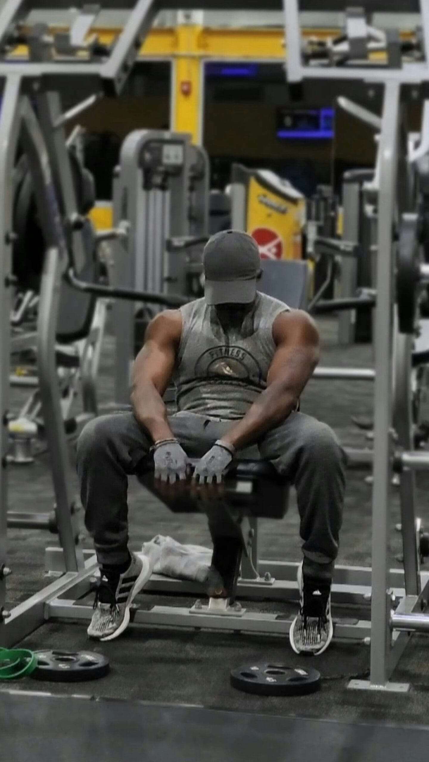 A man sitting on a bench in a gym
